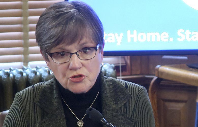 Kansas Gov. Laura Kelly answers questions about the coronavirus outbreak in her state during a news conference, Wednesday, April 1, 2020, at the Statehouse in Topeka, Kan. Kelly says the state is in the “exploratory phase” of determining what to do about containing the virus in its prison system. (AP Photo/John Hanna) RPJH301 RPJH301