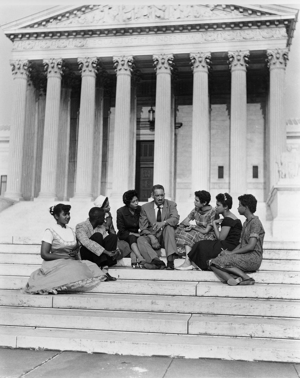 Thurgood Marshall, center, chief legal counsel of the National Association for the Advancement of Colored People, sits on the steps of the Supreme Court Building in Washington, D.C., with some of the members of the Little Rock Nine. (The Associated Press file photo, 1958)