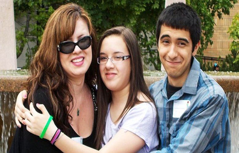Gracie Mercado hugs her children, Frankie and Genni Mercado, several months after a corneal transplant restored her sight.