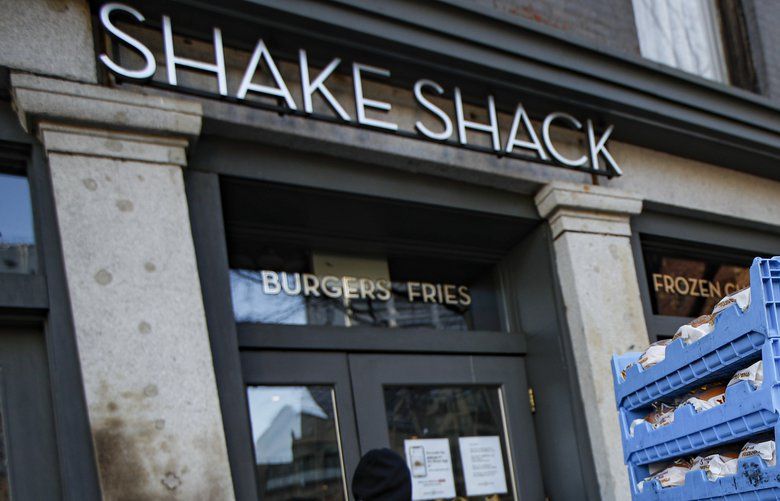 FILE – In this March 16, 2020, file photo, a bread delivery is made to a Shake Shack restaurant in the Brooklyn borough of New York. The burger chain Shake Shack says it will return a small-business loan it got to help weather the coronavirus crisis after topping up its funding. (AP Photo/John Minchillo, File) TKMY101 TKMY101