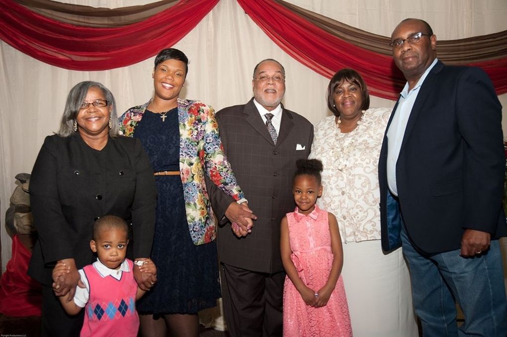 Edwin Kyles Jr., center, and Esther Bryant Kyles, second from right, pose with family members. Pastor Kyles and Mrs. Kyles have died from coronavirus. (Courtesy of family)