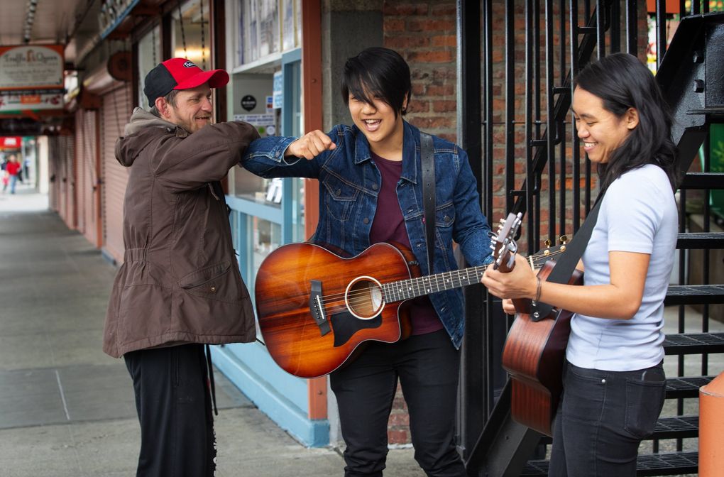 Jeannie Rak gets an elbow bump from Franklin Salogga after Rak and Carly Ann Calbero’s rehearsal Tuesday. (Ellen M. Banner / The Seattle Times)
