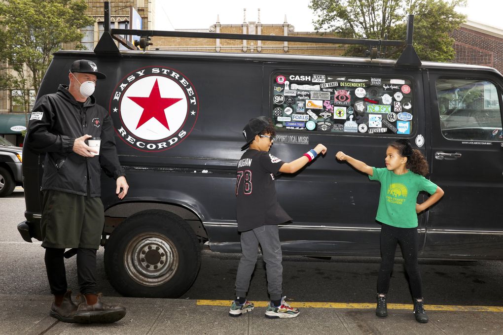 From left: Easy Street Records owner Matt Vaughan is seen with his kids Archie, 8, and Daisy, 6, in West Seattle. Archie and Daisy sometimes help with delivery of records. (Ken Lambert / The Seattle Times)