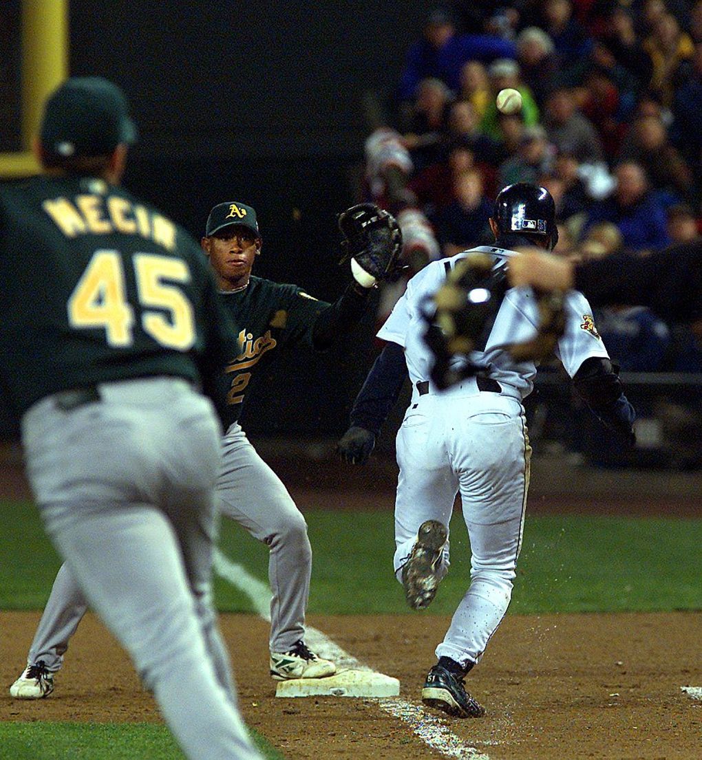 The ball bounces off of Ichiro’s helmet as he beats the throw to first base after a bunt. He advanced to 2nd on the play and moved the winning run to 3rd.
(Mark Harrison / The Seattle Times)