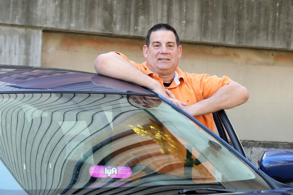 Lyft driver Michael Lowe will benefit from expanded unemployment insurance. (Greg Gilbert / The Seattle Times)