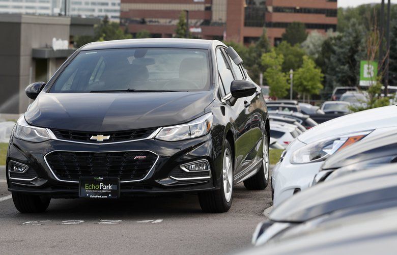 FILE – In this June 26, 2018, file photograph, a used 2017 Chevrolet Cruze sits in a row of other used, late-model sedans at a dealership in Centennial, Colo. Consumers bought an estimated 40.4 million used vehicles last year, likely passing the old record of 40.2 million set in 2018, according to figures from the Edmunds.com auto pricing site. (AP Photo/David Zalubowski, File) NYBZ343