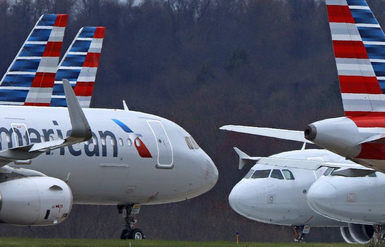 FILE – In this Tuesday, March 31, 2020, file photo, these are some of the 88 American Airlines planes stored at Pittsburgh International Airport in Imperial, Pa. . (AP Photo/Gene J. Puskar, File) 