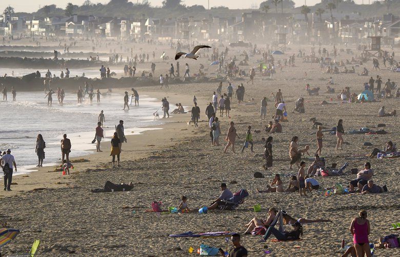Beachgoers spread out the day before the beach is scheduled to close during the coronavirus outbreak, Thursday, April 30, 2020, in Newport Beach, Calif. California Gov. Gavin Newsom on Thursday temporarily closed Orange County’s coastline after large crowds were seen there. (AP Photo/Mark J. Terrill) CAMT107 CAMT107