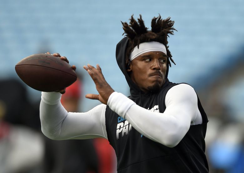 Cam Newton of the Carolina Panthers warms up before playing the New