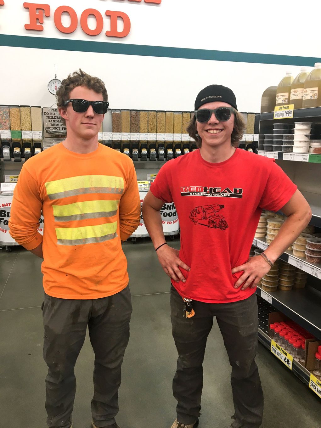 Friends and co-workers Tanner Hall, left, and Micah Strunk, both 20, said they wear masks at work but take them off as soon as possible. At WinCo in Kitsap County on Wednesday, Strunk said he doesn’t understand why people bother wearing cloth masks. (Christine Clarridge / The Seattle Times)