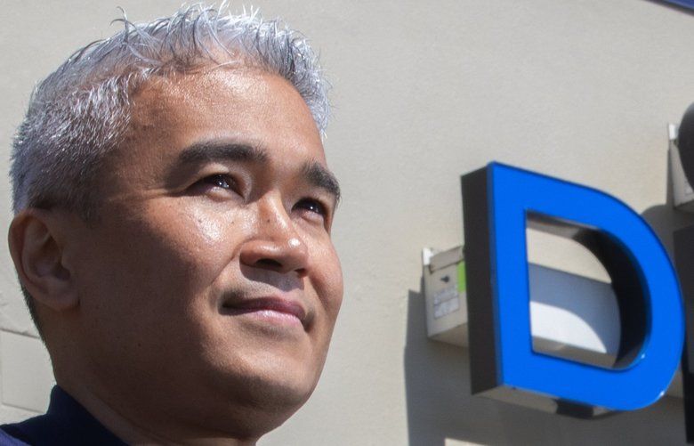 Dr. Arnell Prato, a dentist, stands in front of one of the two locations where he has a practice, Down to Earth Dental, in Tacoma, Wednesday, May 6, 2020.  Prato is one of the lead plaintiffs in a class-action lawsuit filed against insurers who won’t pay small businesses harmed by the coronavirus shutdowns.

 213906
