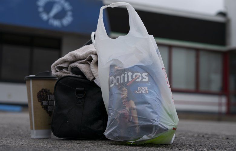 In this April 5, 2020, photo truck driver’s Sammy Lloyd’s shower kit, coffee and Doritos sit on the pavement at the TA Travel Center truck stop in Foristell, Mo., before Lloyd heads out to continue driving a COVID-19 emergency relief load he picked up in California to Virginia. (AP Photo/Carolyn Kaster) DCCK617
