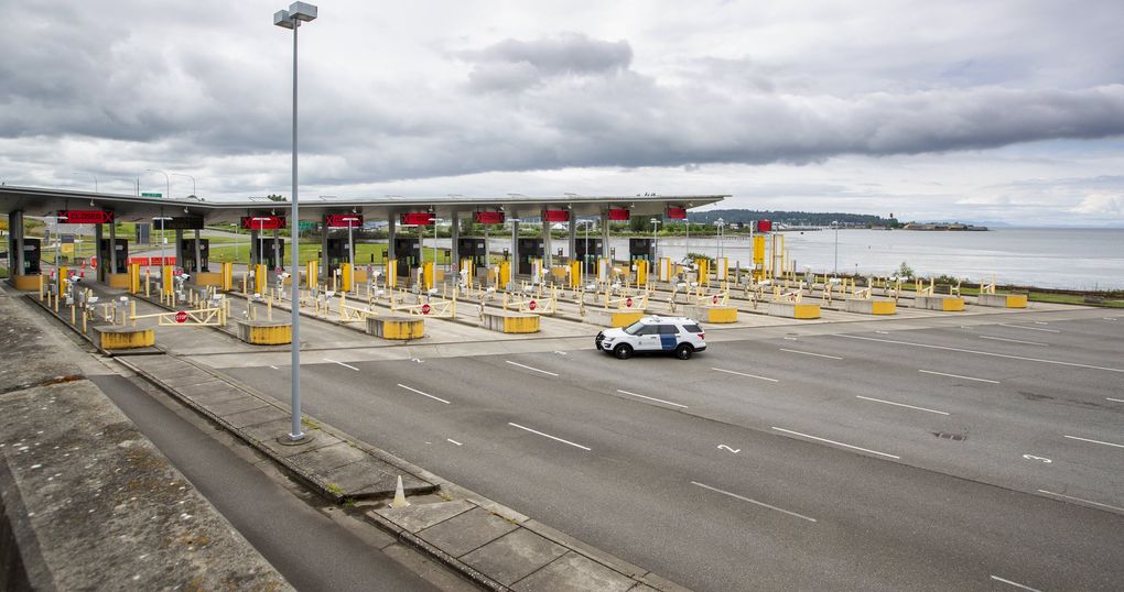 Border crossings have fallen by 98% since the U.S.-Canada border was closed to all but commercial vehicles and “essential” travelers in March. This view is from the U.S. side of the Peace Arch border crossing in Blaine on Wednesday. Semiahmoo Bay is in the distance at right. (Mike Siegel / The Seattle Times)