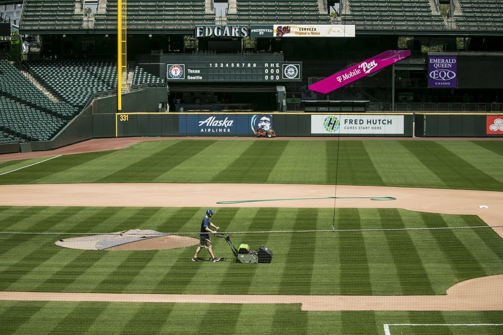Groundscrew member Marcus Gignac mows the infield at T-Mobile Park on Monday, May 11, 2020. (Amanda Snyder / The Seattle Times)