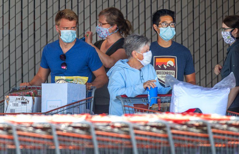 All Costco employees and customers are required to wear protective facial masks while inside the store as seen here at the Aurora Village Costco in Shoreline on Monday afternoon. 
 King County Executive Dow Constantine, Seattle Mayor Jenny Durkan and Public Health Officer Dr. Jeff Duchin have a new directive on facial coverings. 

Photographed on May 11, 2020. 213941