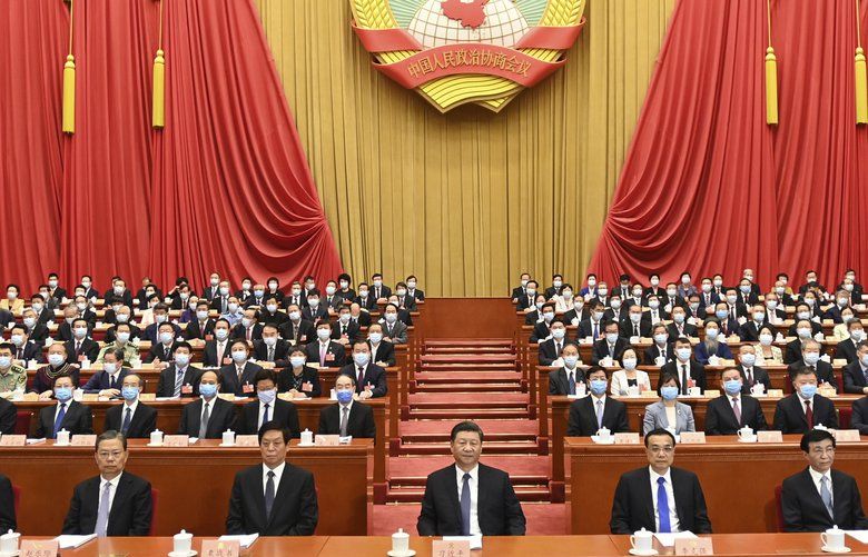 In this photo released by Xinhua News Agency, Chinese President Xi Jinping, center, attends the opening session of the Chinese People’s Political Consultative Conference (CPPCC) at the Great Hall of the People in Beijing, Thursday, May 21, 2020. (Li Xueren/Xinhua via AP) XIN801 XIN801