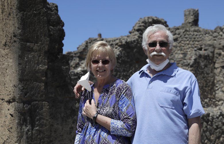 Colleen and Marvin Hewson, from the United States, pose for a photograph during their visit to the archeological sites of Pompeii, near Naples, southern Italy, Tuesday, May 26, 2020. An American couple waited a lifetime plus 2 Â½ months to visit the ancient ruins of Pompeii together. For Colleen and Marvin Hewson, the visit to the ruins of an ancient city destroyed in A.D. 79 by a volcanic eruption was meant to be the highlight a trip to celebrate his 75th birthday and their 30th anniversary. They were among the only tourists present when the archaeological site reopened to the public on Tuesday after the national lockdown to prevent the spread of COVID-19.  (AP Photo/Alessandra Tarantino) ALT101 ALT101
