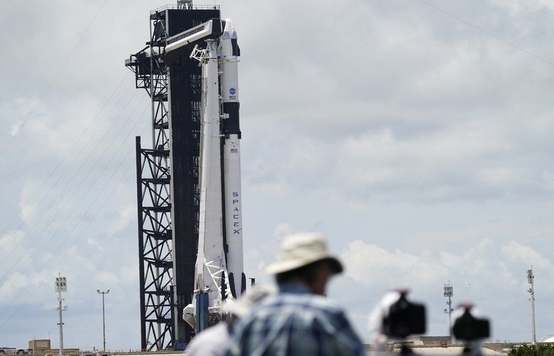 Photographers set up remotes near SpaceX Falcon 9, with Dragon crew capsule on top of the rocket, on Launch Pad 39-A, Friday, May 29, 2020, at the Kennedy Space Center in Cape Canaveral, Fla. Two astronauts will fly on the SpaceX Demo-2 mission to the International Space Station scheduled for launch on Saturday, May 30. For the first time in nearly a decade, astronauts will blast into orbit aboard an American rocket from American soil, a first for a private company. (AP Photo/David J. Phillip) MH103 MH103