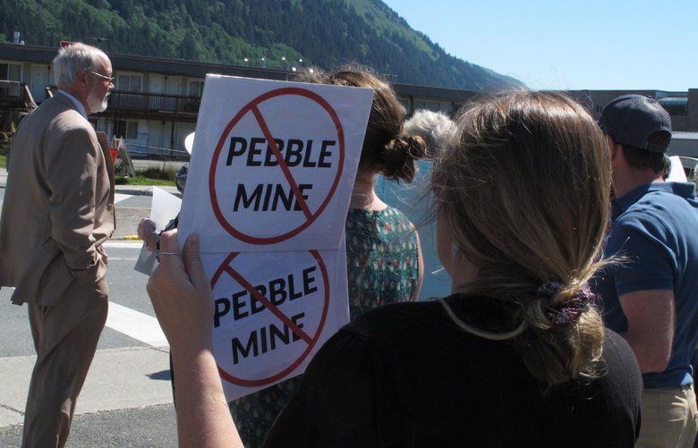 People gather outside U.S. Sen. Lisa Murkowski’s office in Juneau, Alaska, last year to protest the proposed Pebble Mine.  (AP Photo/Becky Bohrer, file) 