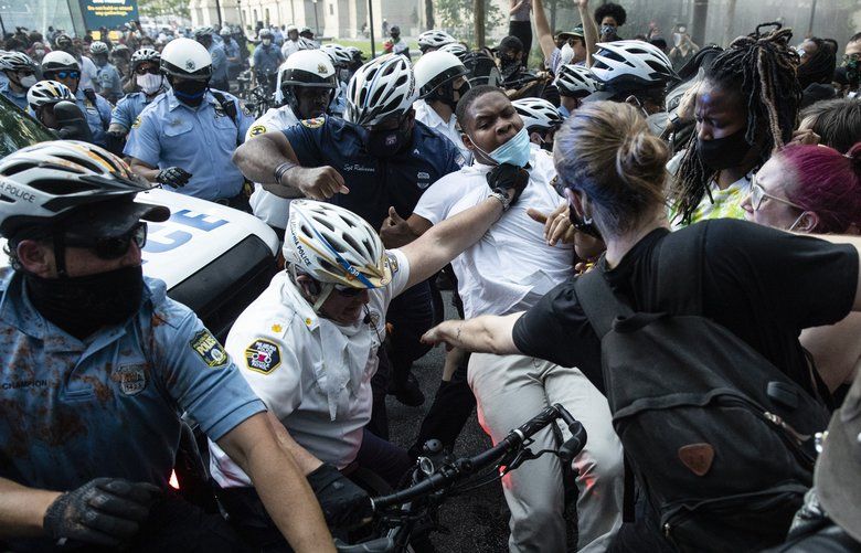 Police and protesters clash Saturday, May 30, 2020, in Philadelphia, during a demonstration over the death of George Floyd. Protests were held throughout the country over the death of Floyd, a black man who died after being restrained by Minneapolis police officers on May 25.. (AP Photo/Matt Rourke) PAMR107 PAMR107