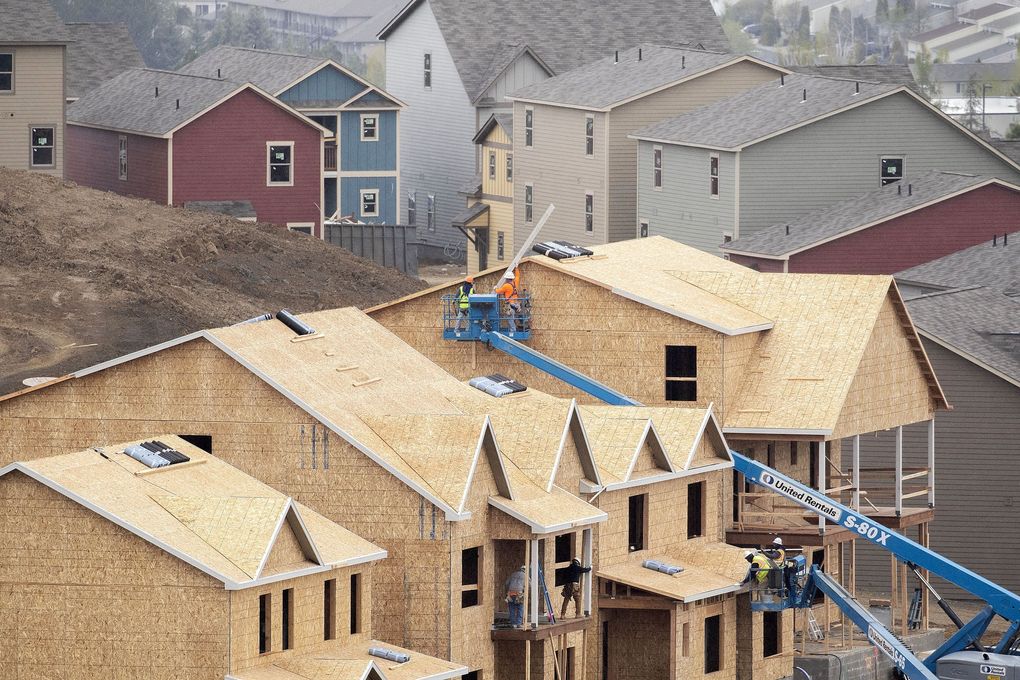 A construction crew works on a building being built in the Retreat At Pullman development on NE Merman Drive on Monday, April 27, 2020, in Pullman., Wash. Work on the project was shut down from March 23 and until April 24 as part of Gov. Jay Inslee’s order to prevent the spread of the coronavirus. (Geoff Crimmins/Moscow-Pullman Daily News via AP)