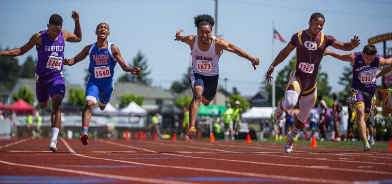 O’Dea’s Myles Gaskin (1587) comes out of lane three to win the boy’s Class 3A 100 meters, defeating runner-up Emmanuel Wells of Rainier Beach (1640) and third place Rashad Swank-Jones (1284) of Garfield at the state track and field meet in 2015.  (Dean Rutz / The Seattle Times)