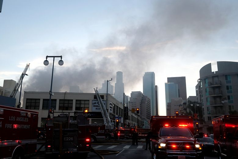 Smoke rises from the scene of a structure fire that injured multiple firefighters, according to a fire department spokesman, Saturday, May 16, 2020, in Los Angeles. (AP Photo/Ringo H.W. Chiu)
