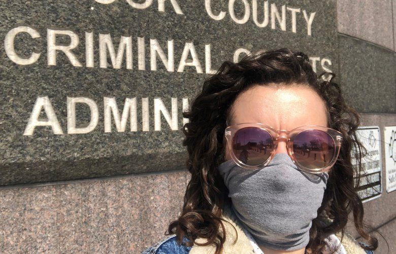 Chicago Tribune criminal courts reporter Megan Crepeau at the Cook County Courthouse at the corner of 26th and California. During the pandemic, she must observe social distancing rules and wear a mask. Though it is one of the busiest criminal courts in the nation, Crepeau has been furloughed one week per month while Tribune Publishing Co. deals with the economic effects of the pandemic.