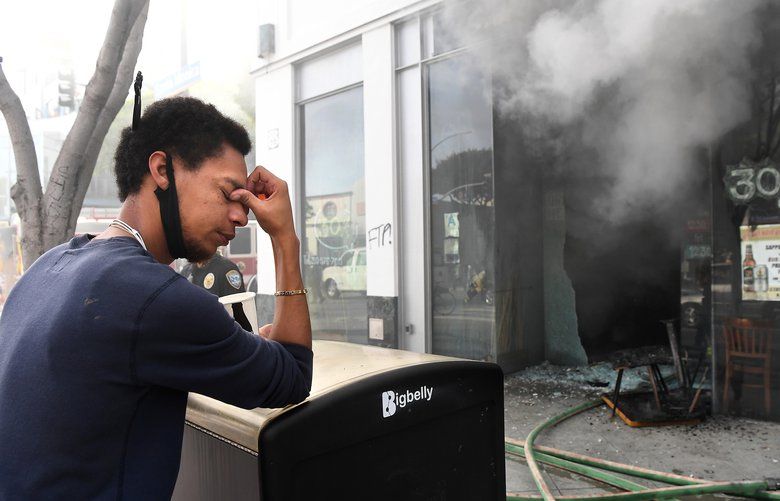 Sake House employee Jared Settles can’t bear to watch as the restaurant burns in Santa Maonica Sunday, May 31, 2020. (Wally Skalij/Los Angeles Times/TNS)