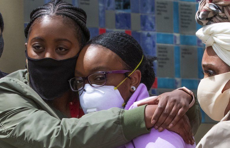 Monet Carter-Mixon (c), sister of Manny Ellis, gets a hug from Jalessa Trapps with the Tacoma Action Collective after a press conference in front of the Pierce County Superior Court Thursday, June 4, 2020 regarding the killing of her brother by Tacoma police.  At right is Marcia Carter, mother of Manny Ellis.

Tacoma police’s restraint of Manuel Ellis caused his death the medical examiner has reported. The community has been protesting the death that happened March 3, 2020, for the past week.
 214156