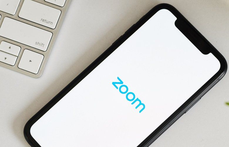 The logo for the Zoom Video Communications Inc. application is displayed on an Apple Inc. iPhone in an arranged photograph taken in the Brooklyn borough of New York, U.S., on Friday, April 10, 2020. Zoom’s shares have soared in 2020 as the popularity of its video conferencing service has grown during a time of widespread lockdowns aimed at stemming the spread of the coronavirus pandemic. Photographer: Gabby Jones/Bloomberg 775504458