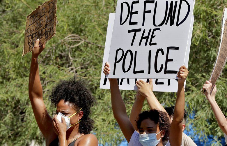 Protesters rally Wednesday, June 3, 2020, in Phoenix, demanding the Phoenix City Council defund the Phoenix Police Department. The protest is a result of the death of George Floyd, a black man who died after being restrained by Minneapolis police officers on May 25. (AP Photo/Matt York) AZMY103 AZMY103