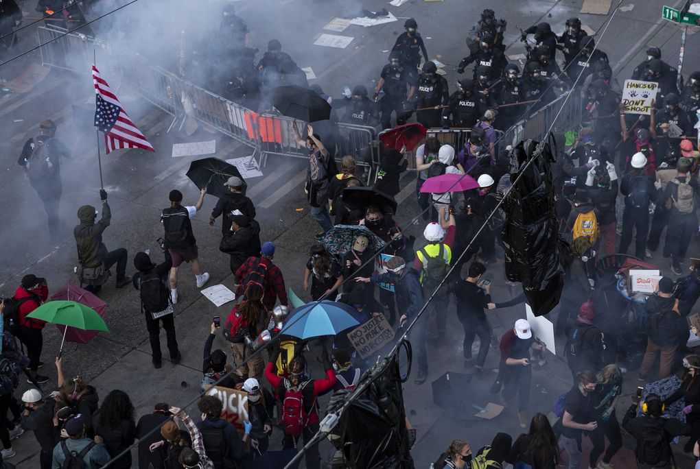 Seattle police clear protesters near Cal Anderson Park on Capitol Hill recently. A group of plaintiffs, including Black Lives Matter activists, protesters and a journalist, has filed a lawsuit against the city of Seattle over its use of tear gas and other chemicals on protesters.(Erika Schultz / The Seattle Times)