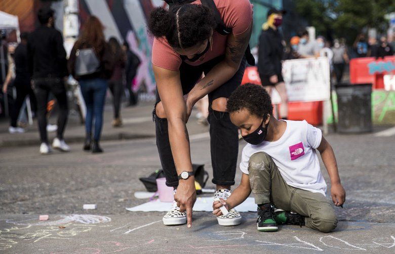 Xander Cannon, 5, and his mother Falon Sierra draw rainbows on the intersection of 11th Avenue and Pine Street on Wednesday in the Capitol Hill Autonomous Zone, declared by protesters after law enforcement left the area earlier this week. 

June 10, 2020 214233