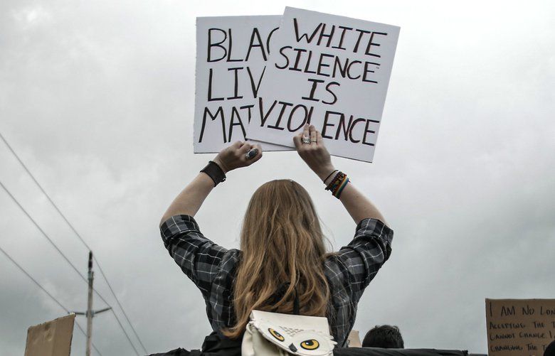 A protester holds a sign at a Black Lives Matter protest in Silverdale on June 6, 2020.