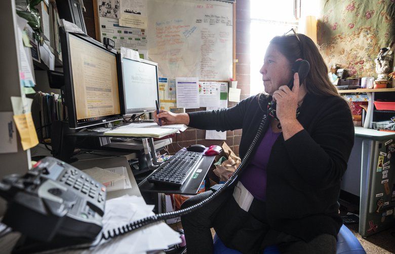 Kimberly Steele-Peter, a supervisor for a team of contact tracers at the Tacoma Pierce County Health Department, makes a call to a person who may have been exposed to coronavirus. (Steve Ringman / The Seattle Times)