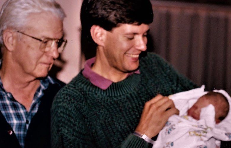 Brian J. Cantwell holds his newborn daughter, Lillian, as his father, Joe Cantwell, looks on, in 1991.