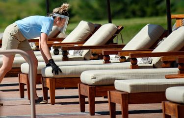 Staff in protective face shields prepare the pool area for guests on May 30,2020, at Falling Rock, one of several hotels at Nemacolin Woodlands Resort in Wharton, Pa. MUST CREDIT: Photo for The Washington Post by Jeff Swensen 20200530
