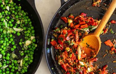 Peas, left, and roasted peppers are prepared for use in a cheesy potato cake. (Andrew Scrivani/The New York Times) XNYT87