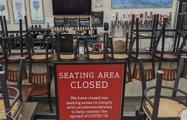 FILE – In this March 26, 2020, file photo, an indoors sitting bar is closed inside the Gelson’s Market in Los Feliz neighborhood of Los Angeles. Gov. Gavin Newsom on Sunday, June 28, 2020, ordered bars that have opened in seven California counties to immediately close and urged bars in eight other counties to do the same, saying the coronavirus was rapidly spreading in some parts of the state. The counties under the mandatory bar closure order are: Los Angeles, Fresno, San Joaquin, Kings, Kern, Imperial and Tulare. (AP Photo/Damian Dovarganes, File) CADD420 CADD420