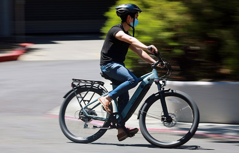  Tech writer Brian Chen rides the electric Ride 1Up 700, which sells for $1,495. A VanMoof S3 e-bike cost $1,998. (Jim Wilson / The New York Times) For use with NYT story by Brian X. Chen