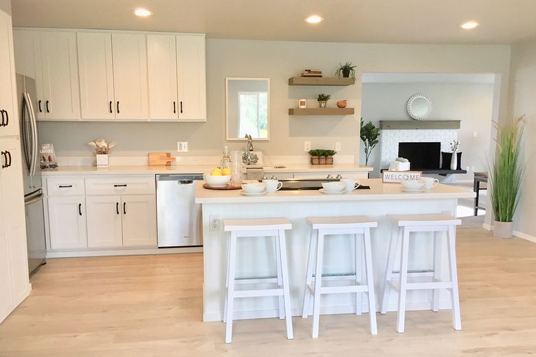 Stained plywood box houses kitchen and bedroom in renovated Seattle condo