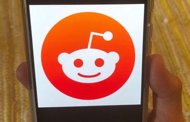 This Monday, June 29, 2020 photo shows the Reddit logo on a mobile device in New York. Reddit, an online comment forum that is one of the internet’s most popular websites, on Monday, June 29, 2020 banned a pro-Donald Trump forum as part of a crackdown on hate speech. Reddit banned a total of 2,000 of these forums, or subreddits, most of which it said were inactive or had few users. (AP Photo/Tali Arbel) RPTA201 RPTA201