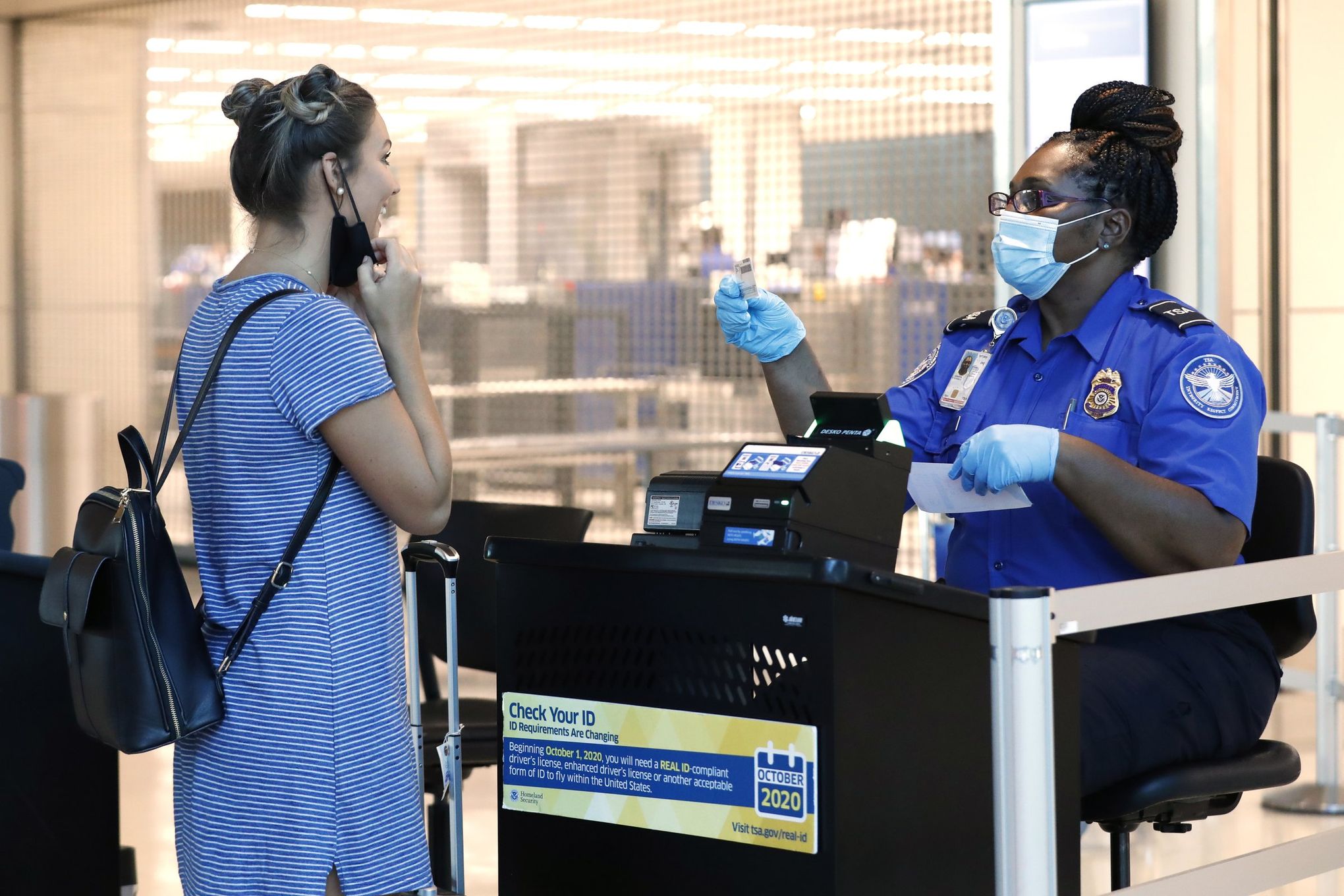 A TSA employee advises travelers that liquids are not allowed through the  gate at at the Los Angeles International Airport Wednesday, Oct. 10, 2012.  In an age when travelers have to toss