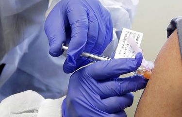 In this file photo from March 16, 2020, a patient receives a shot in the first-stage safety study clinical trial of a potential vaccine for COVID-19, the disease caused by the new coronavirus, at the Kaiser Permanente Washington Health Research Institute in Seattle. When precious vats of COVID-19 vaccine are finally ready, the ability to jab the lifesaving solution into the arms of Americans will require hundreds of millions of injections.
(AP Photo/Ted S. Warren, File)