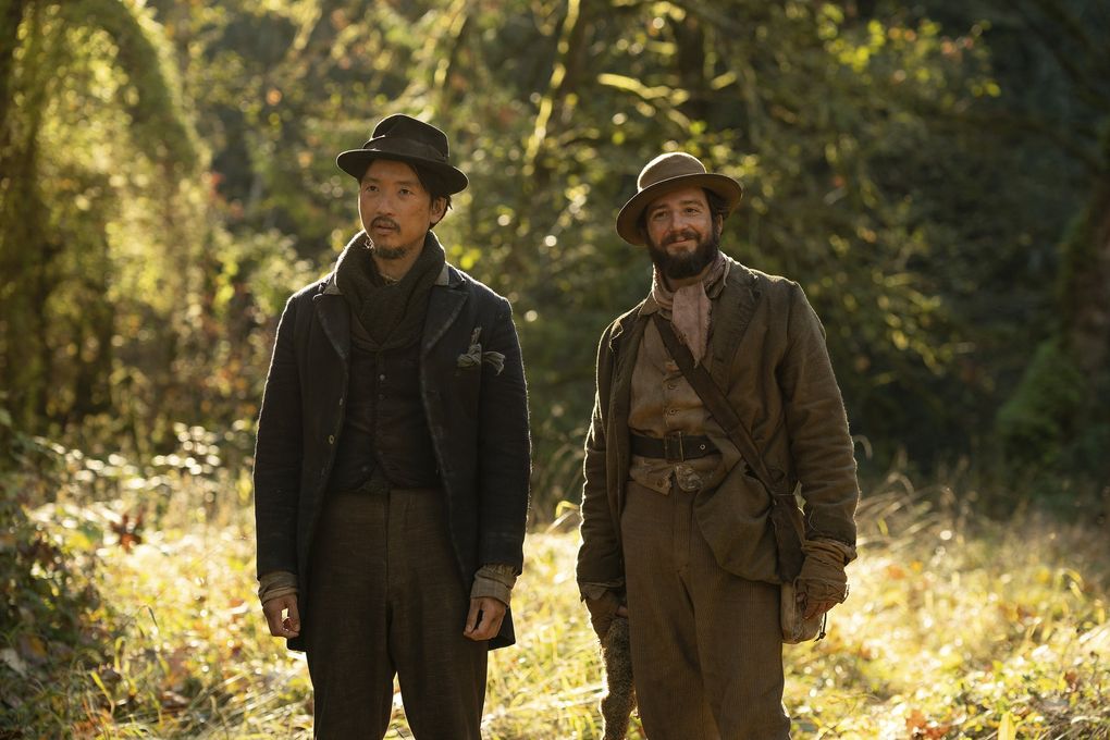 “First Cow,” starring Orion Lee (left) and John Magaro, follows the tale of an unlikely friendship in 1820s Oregon. (Allyson Riggs / A24 Films via AP)