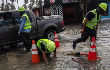 City of Corpus Christi employees work to drain a road flooded by Hurricane Hanna in Corpus Christi, Texas, July 26, 2020. (Tamir Kalifa/The New York Times) XNYT116 XNYT116