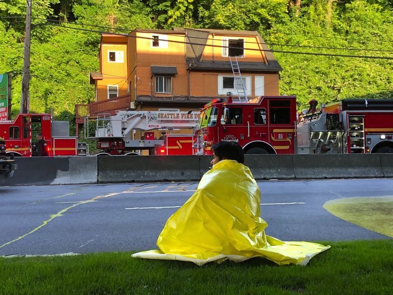 Two people were killed in an early-morning fire on  Aurora Avenue on July 13. The suspect was charged Friday. (Mike Siegel / The Seattle Times)