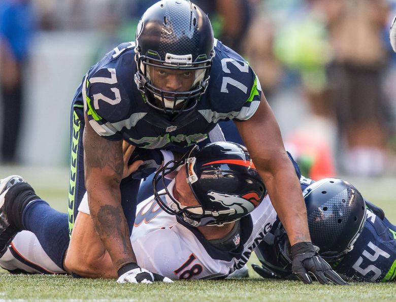 Seahawks DE Bennett celebrates with bicycle ride