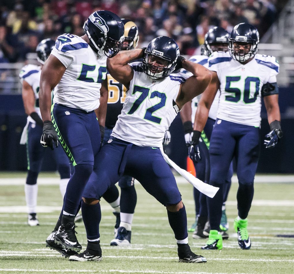 Seahawks defensive lineman Michael Bennett celebrates a sack on Rams quarterback Nick Foles on Sept. 13, 2015.(Bettina Hansen / The Seattle Times)
